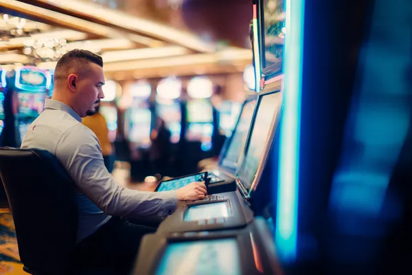 A young woman relaxing with her phone while dynamic casino elements float around her, illustrating the smooth mobile experience offered by the BANGBED app.