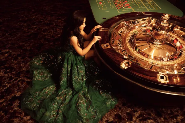 A glamorous woman holding casino chips in a neon-lit environment, representing the premium online casino atmosphere of BANGBED.